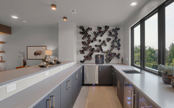 WineHive Black modular honeycomb wine rack wall in a modern kitchen